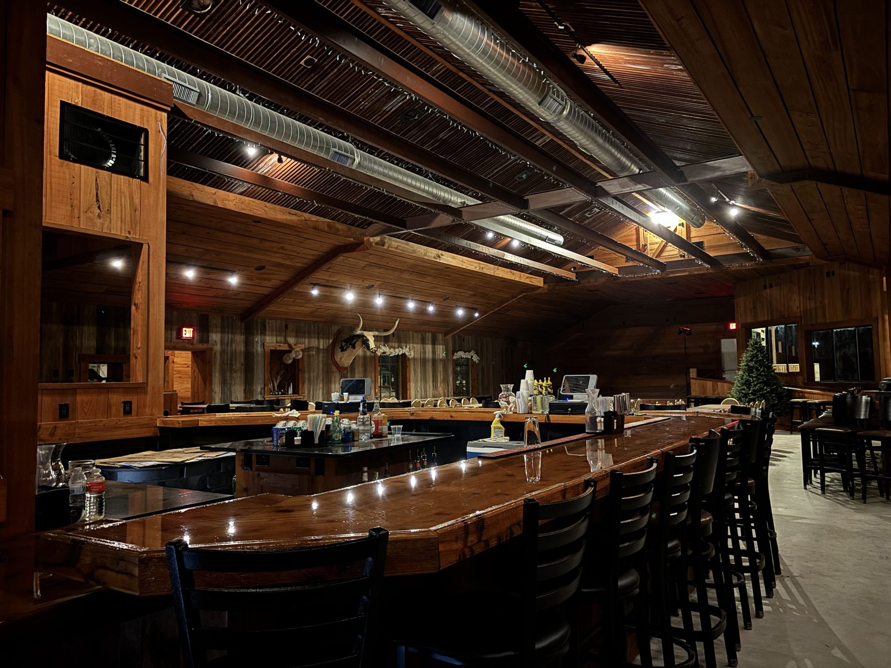 The main bar inside the Longhorn dancehall, with the venue's longhorn skull above the stage.